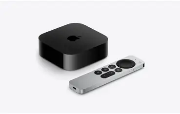 Black Apple TV box with silver remote on a light background