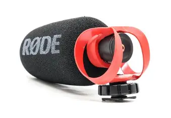 RØDE VideoMicro II microphone with black foam windshield, red suspension mount and black shoe foot on white